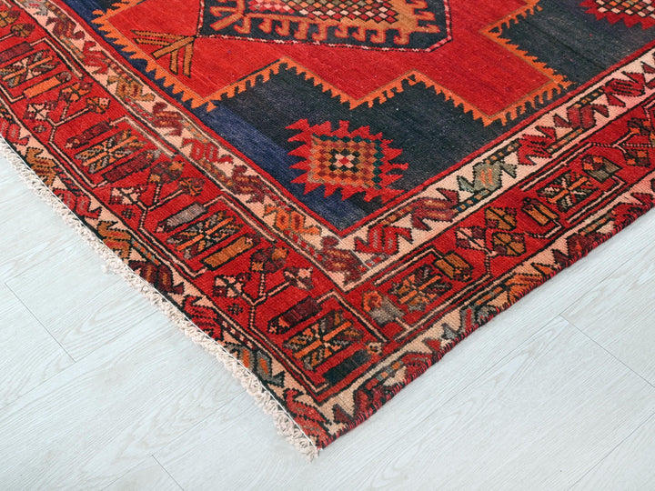 a red and blue rug on a white floor