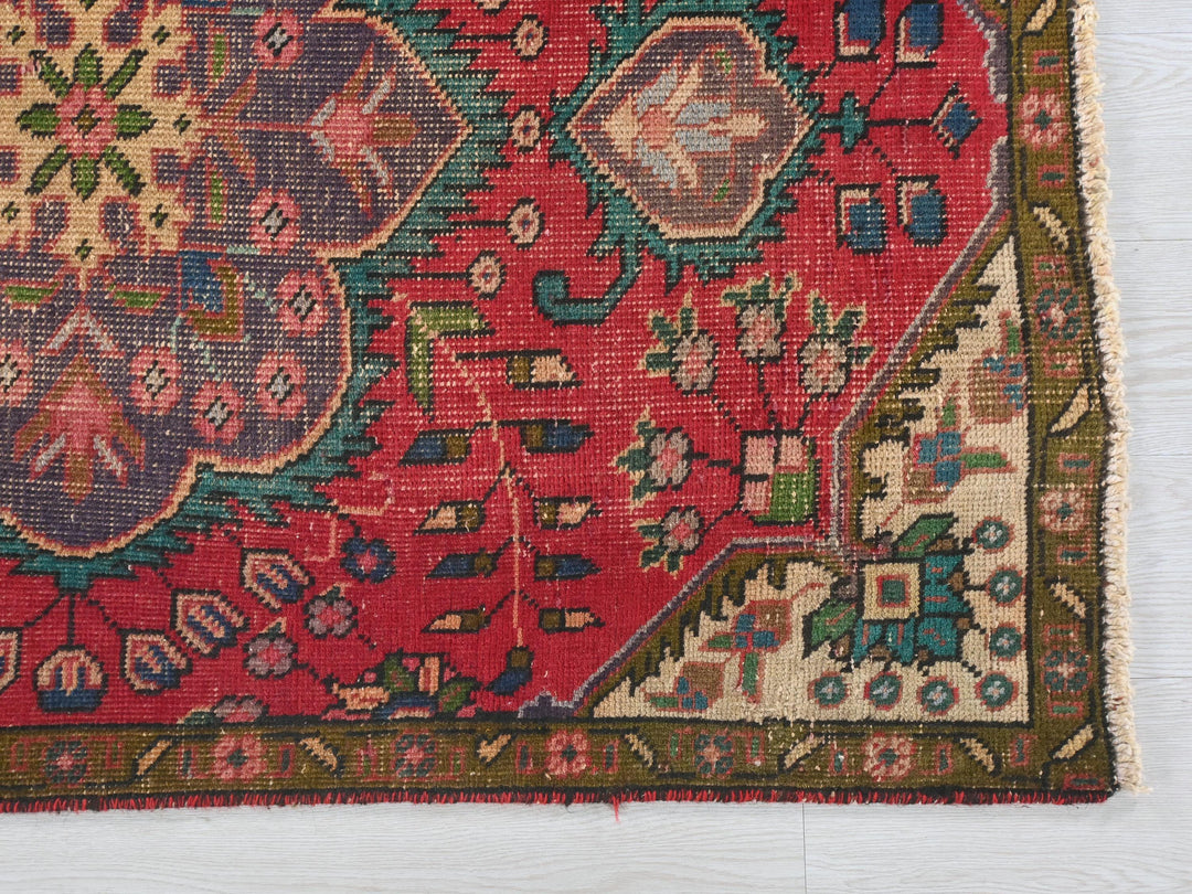 a red rug with a colorful design on it