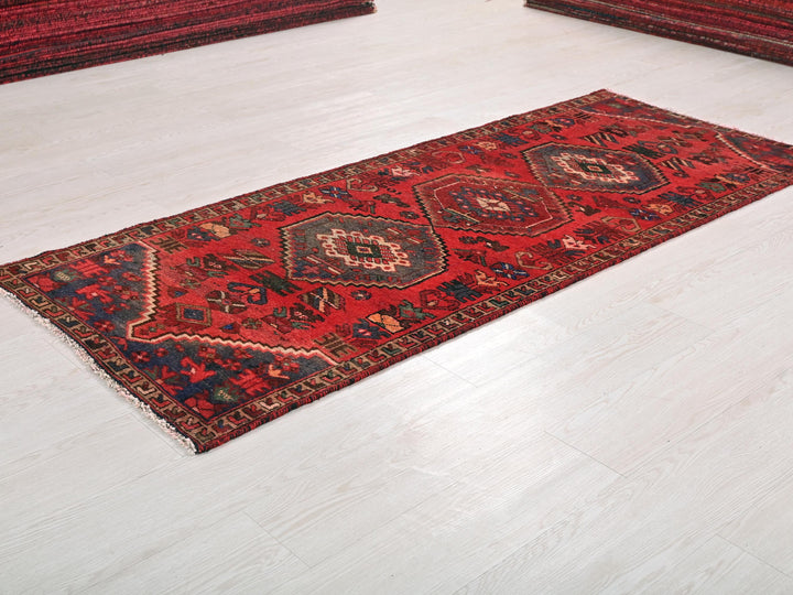 a red rug on the floor of a room