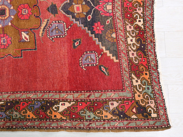 a red rug with a floral design on it