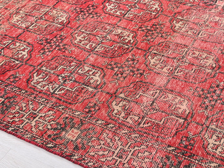 a red rug with a black and white design