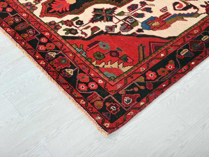 a red and black oriental rug on a white floor