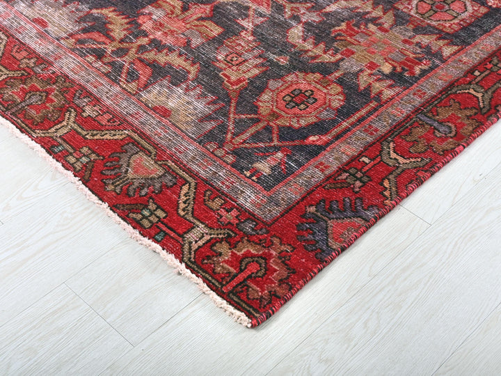 a red and blue rug on a white floor