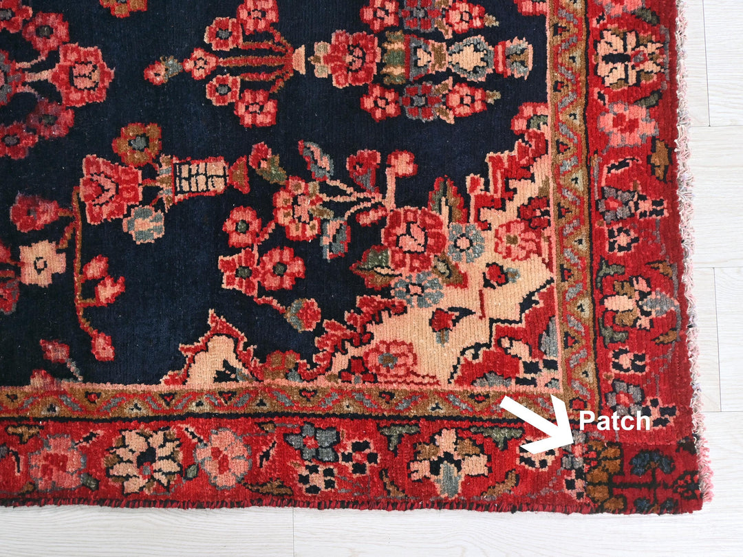 a red and blue rug with an arrow pointing to it