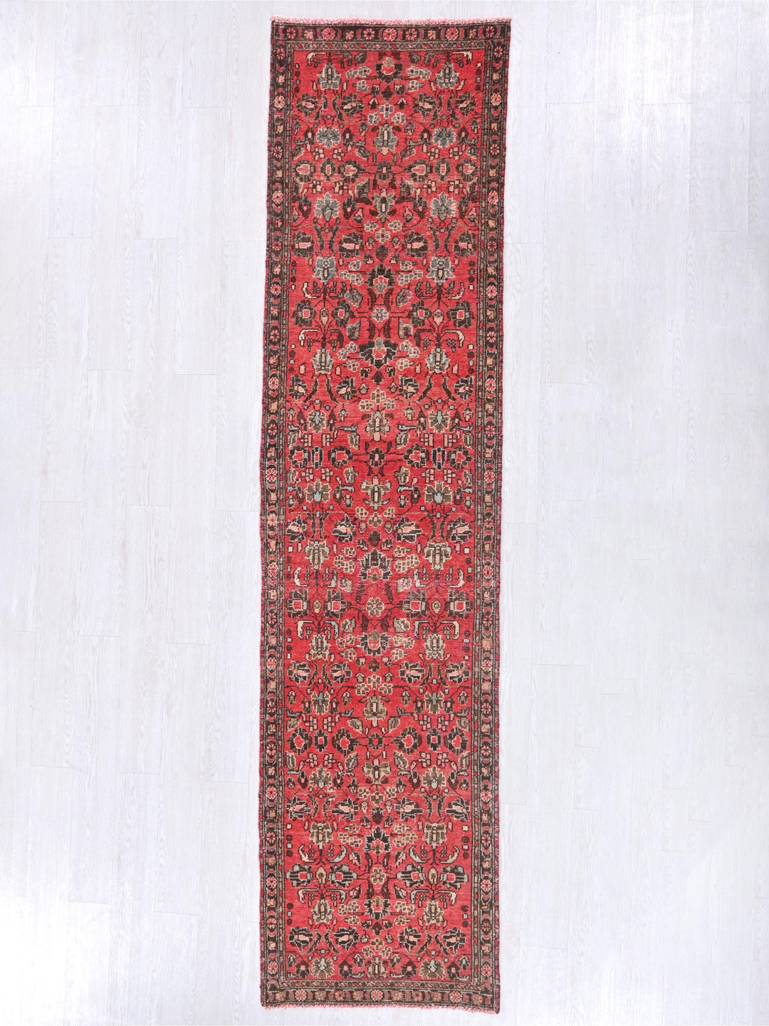 a red rug hanging up against a white wall