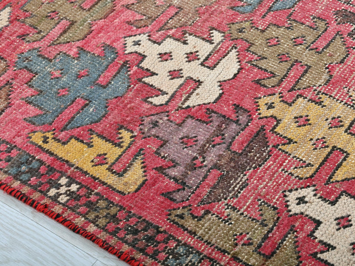 a red rug with a pattern of dogs on it