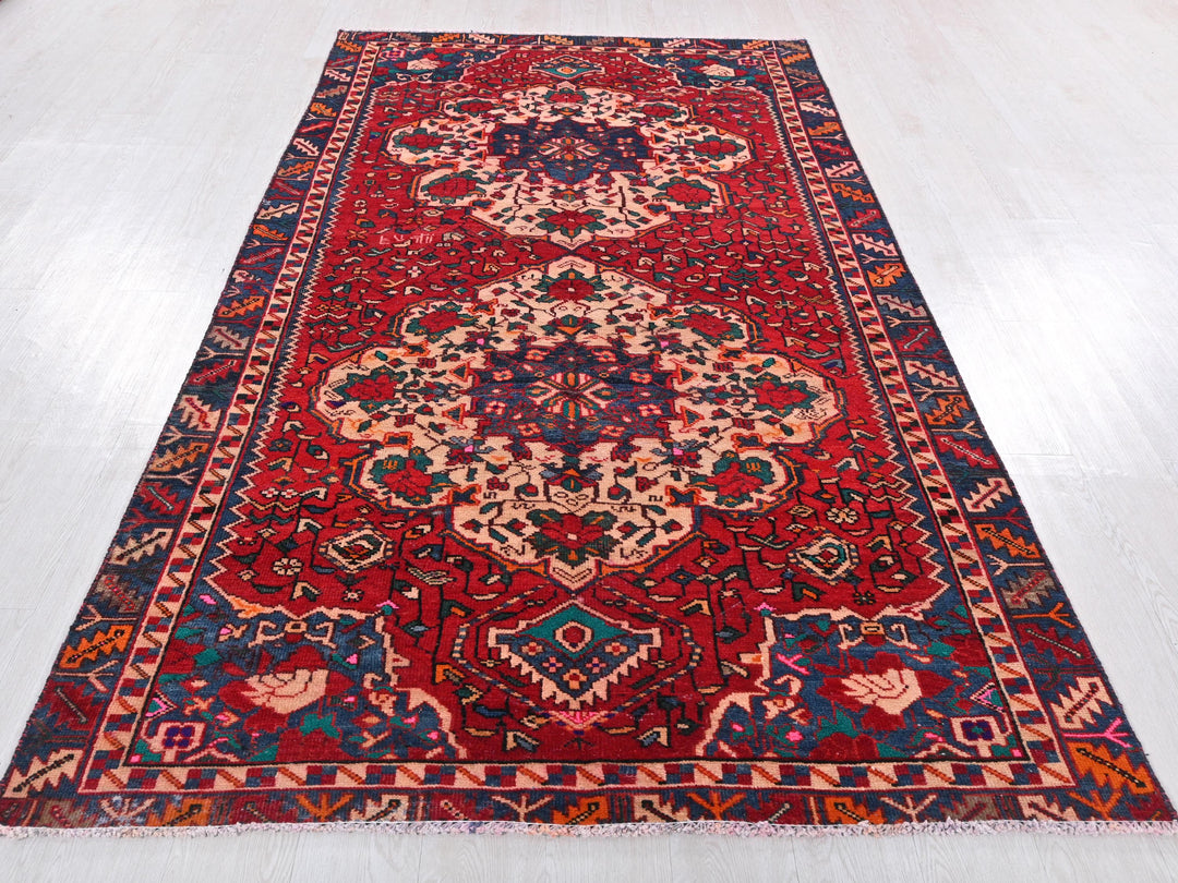 a red rug with a blue and red design on it