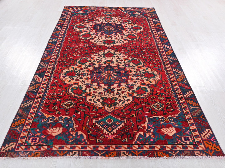 a red rug with a blue and red design on it