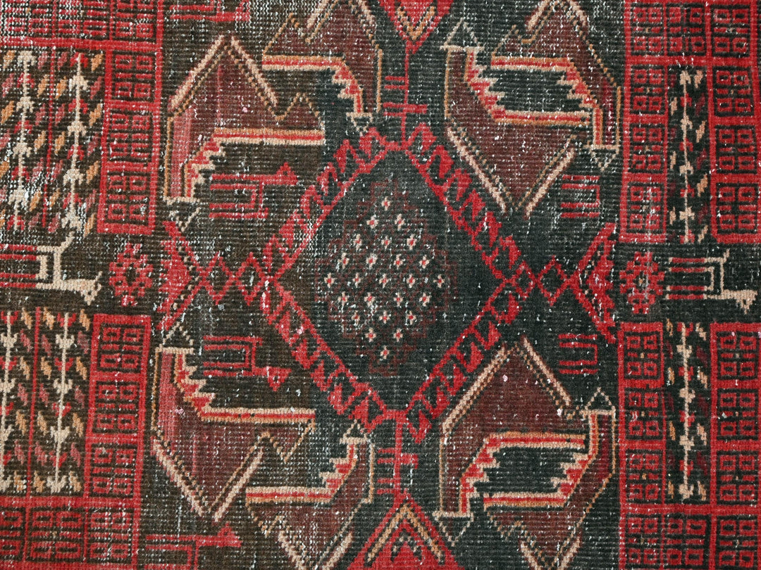 a close up of a red and black rug