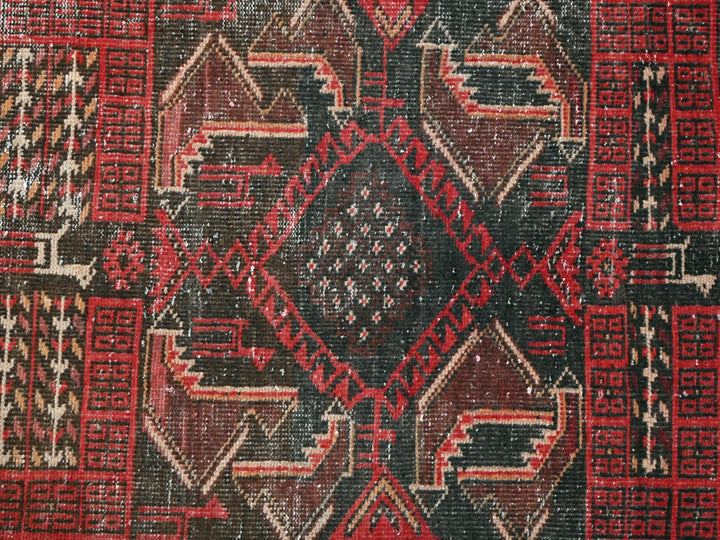 a close up of a red and black rug