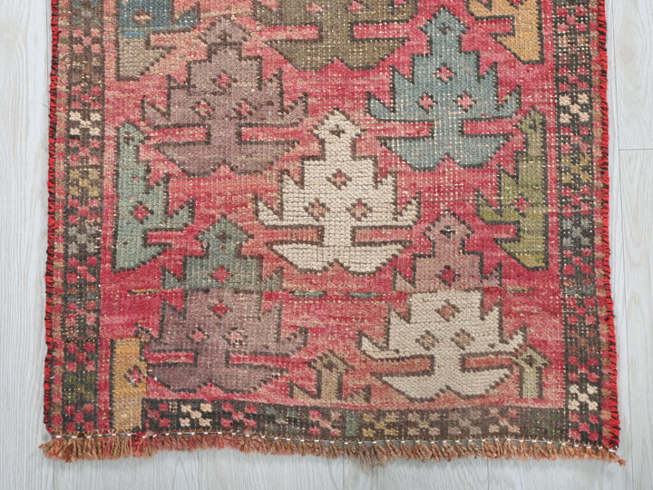 a red rug with a pattern on the middle of it