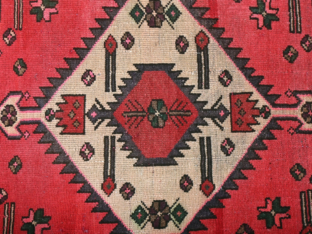 a close up of a red and black rug