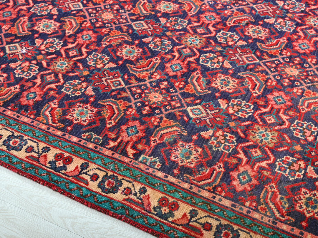 a red and blue rug on a white floor