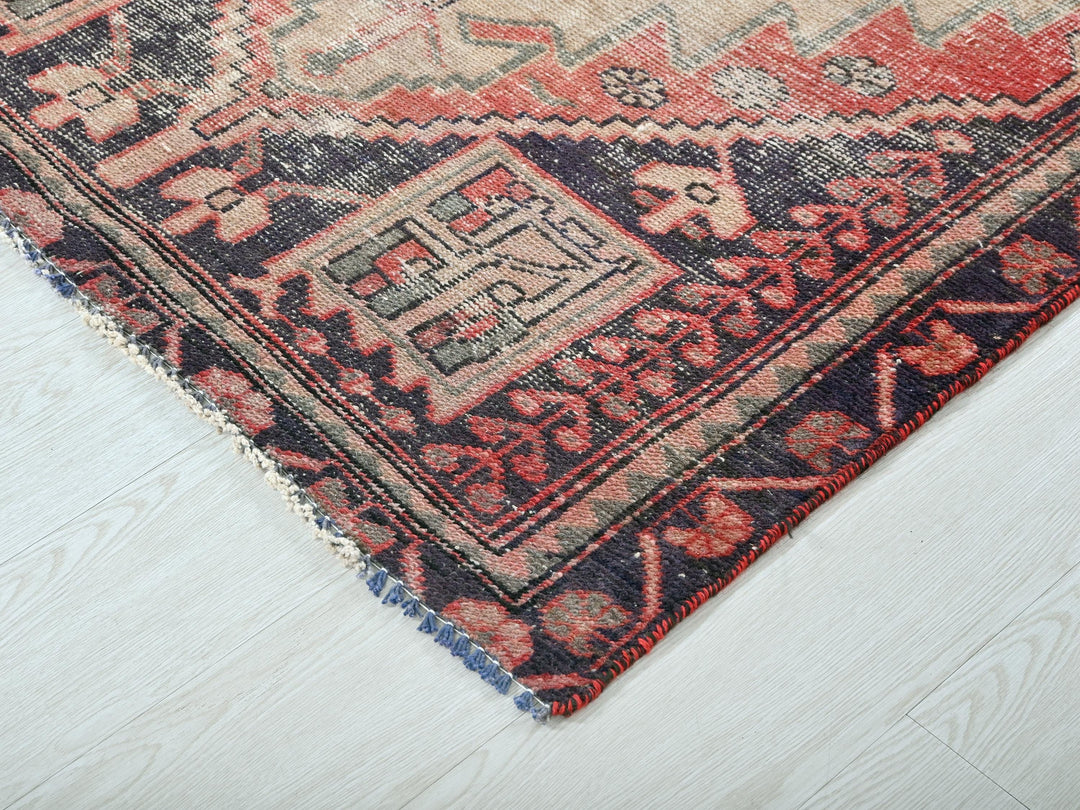 a red and blue rug on a white floor