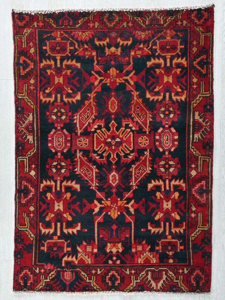a red and black rug on a white wall