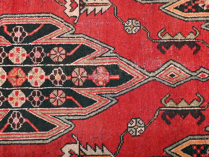 a close up of a red oriental rug