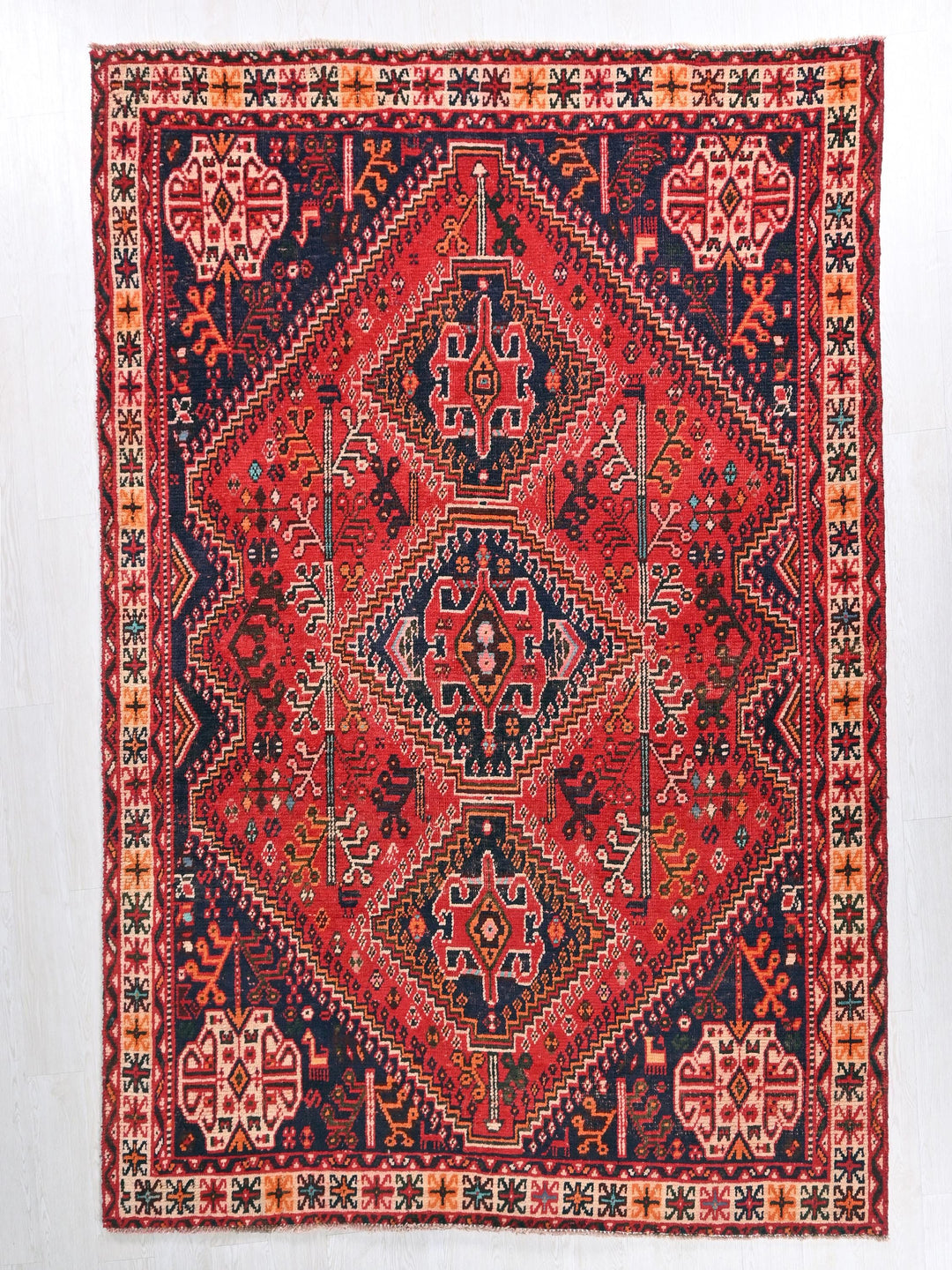 a red and blue rug with a diamond design