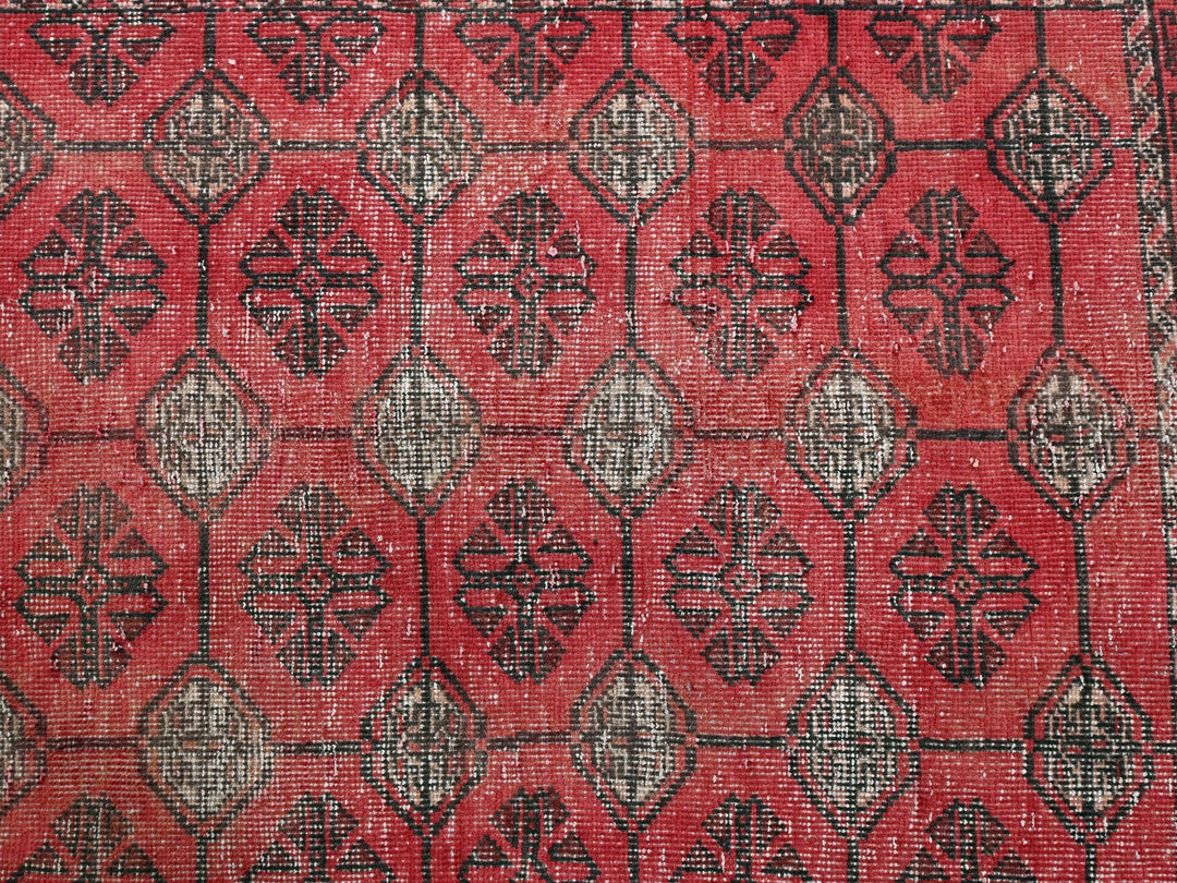 a red and black rug with a design on it