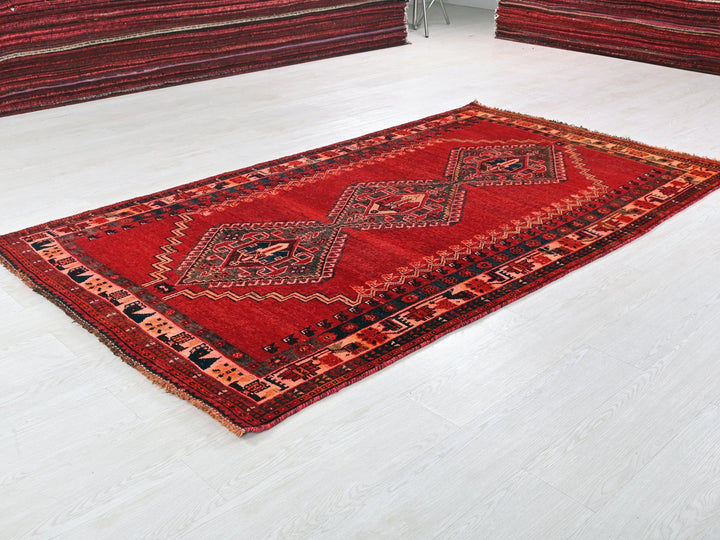 a red rug on the floor of a room