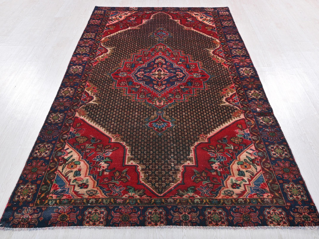 a red and blue rug on a white floor