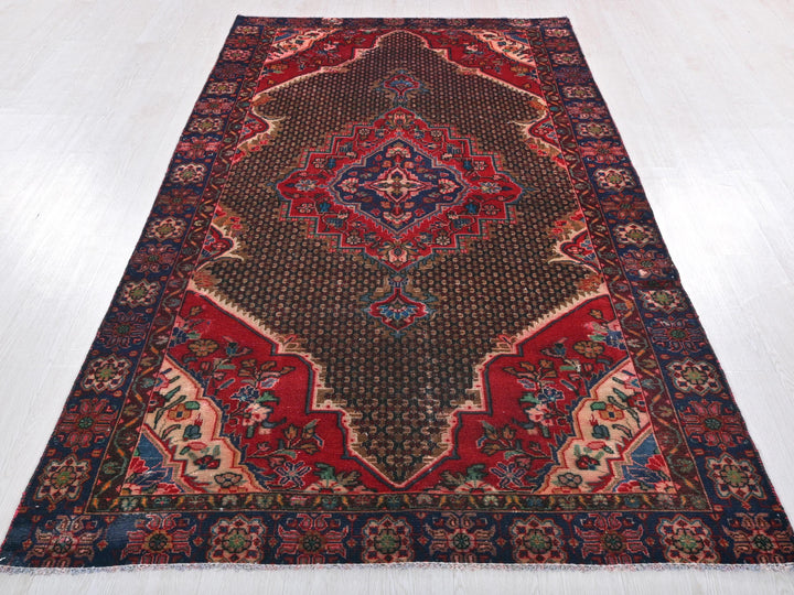 a red and blue rug on a white floor