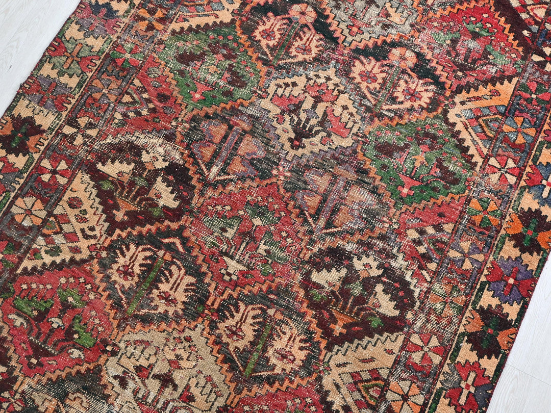 a colorful oriental rug on a white wooden floor