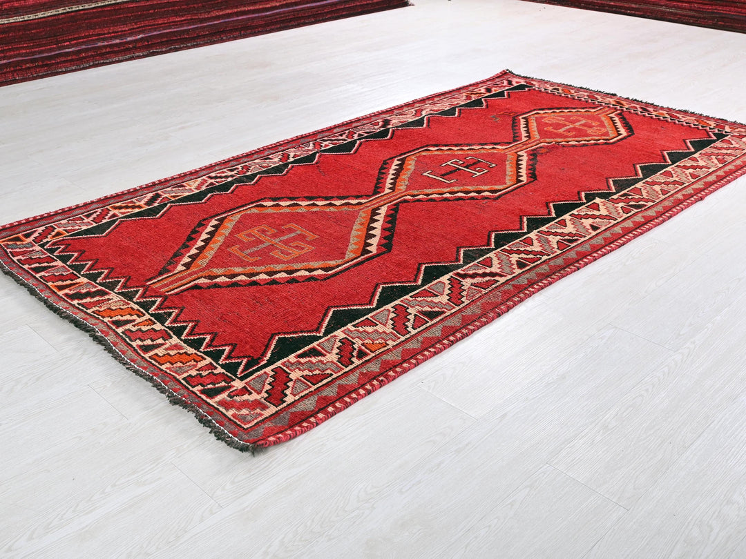 a red rug on the floor of a room