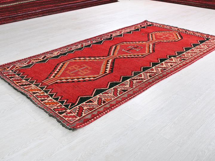 a red rug on the floor of a room