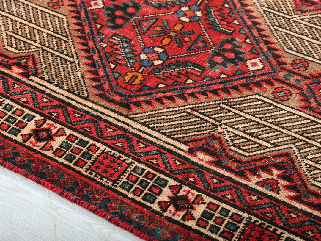 a close up of a red and black oriental rug