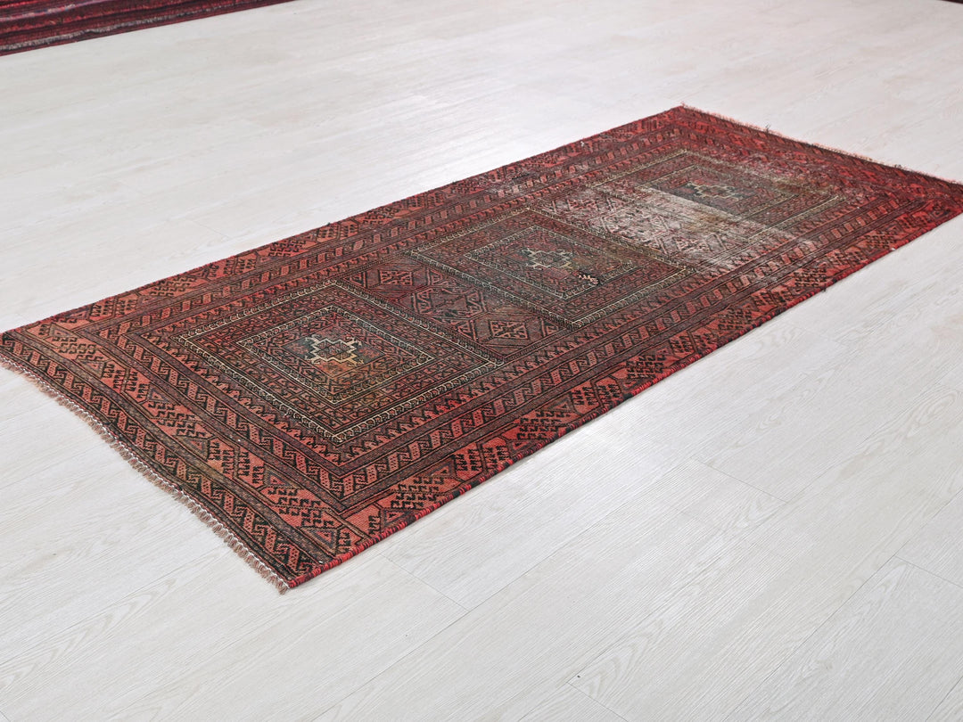 a red rug on a white floor in a room