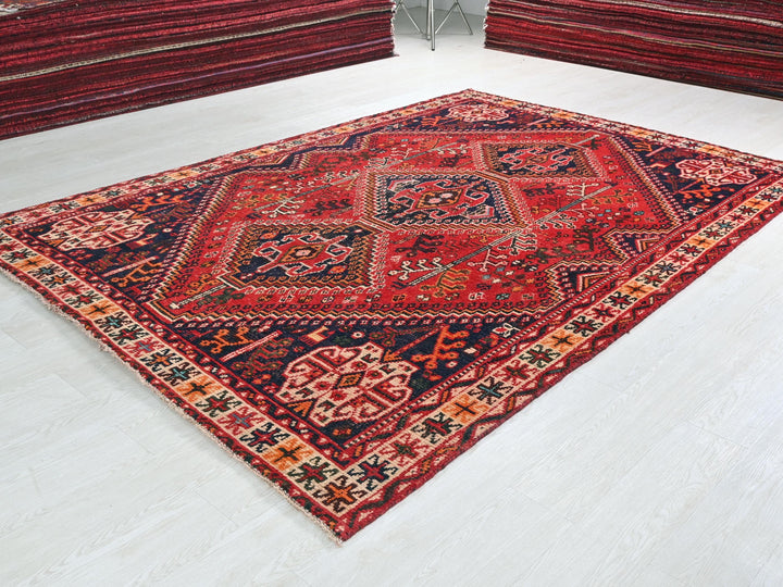a large red rug on the floor of a room