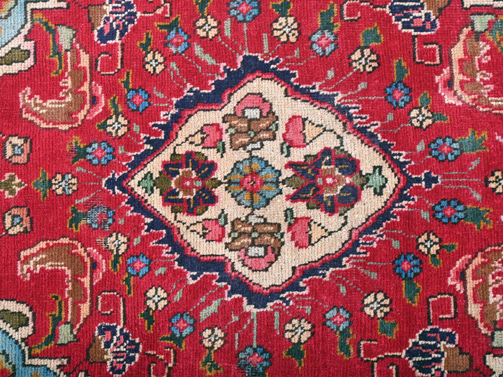 a close up of a red rug with a floral design