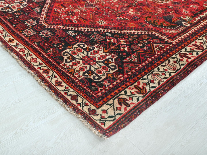 a red oriental rug on a white floor