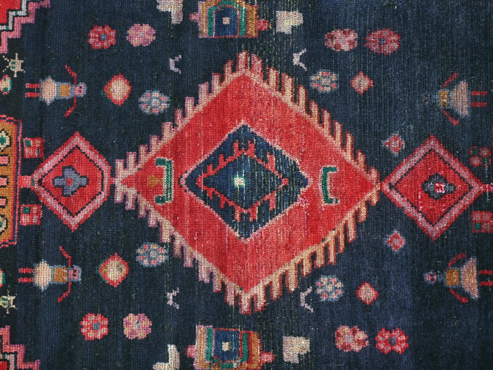 a blue and red rug with a diamond design