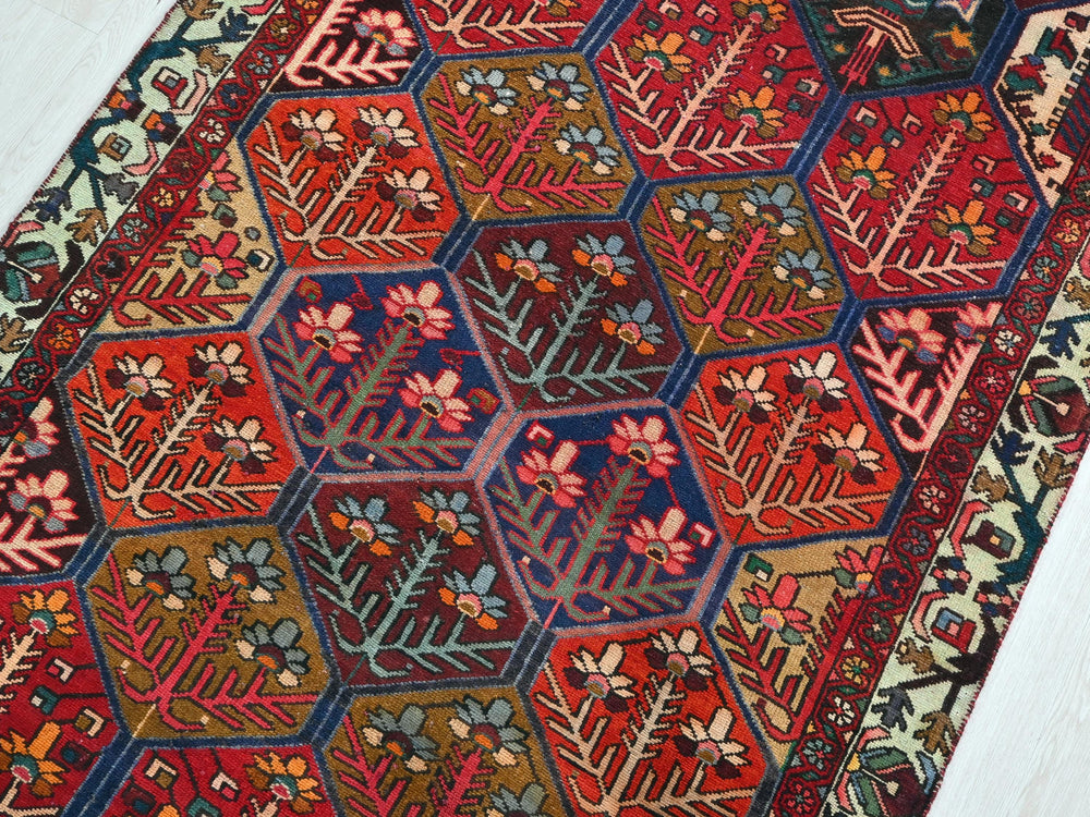 a red rug with a hexagonal design on it