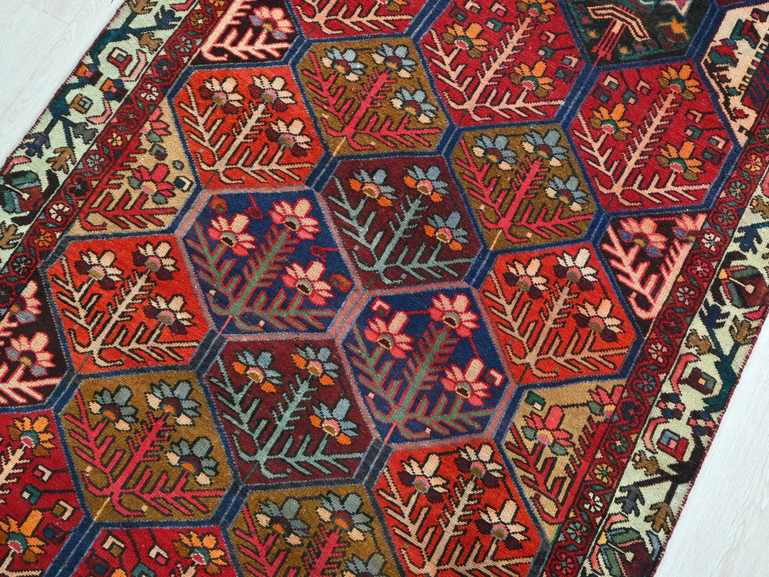 a red rug with a hexagonal design on it