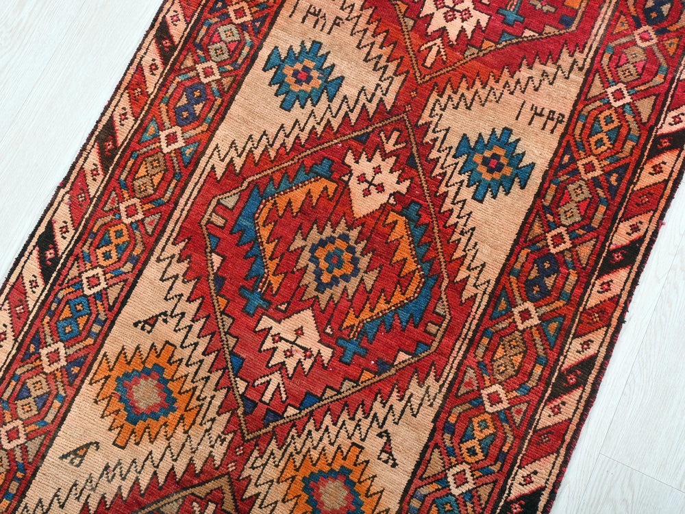 a red and blue rug on a white floor