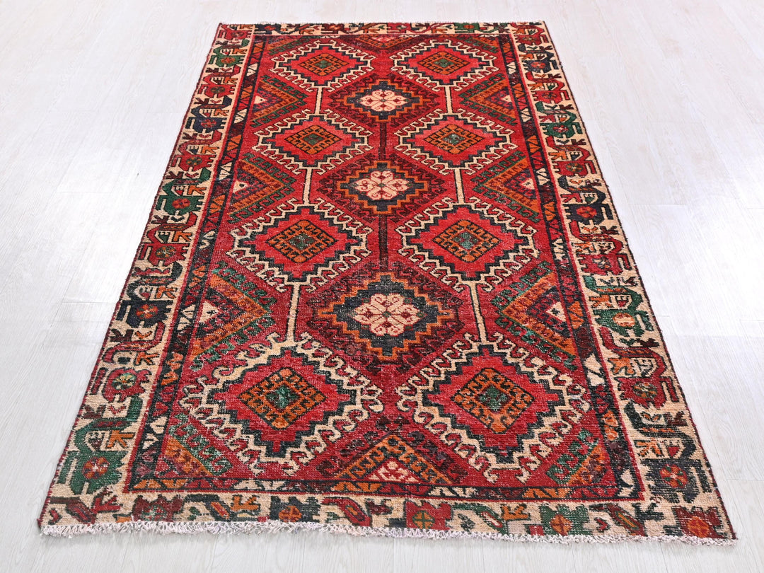a red and green rug on a white floor