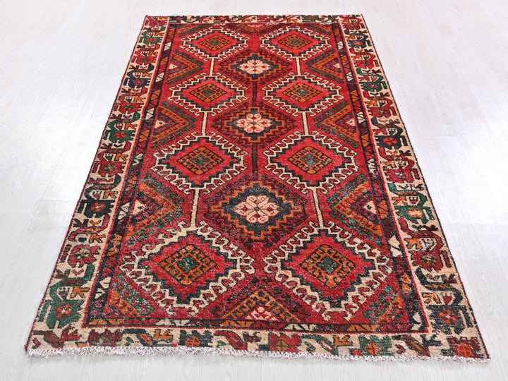 a red and green rug on a white floor