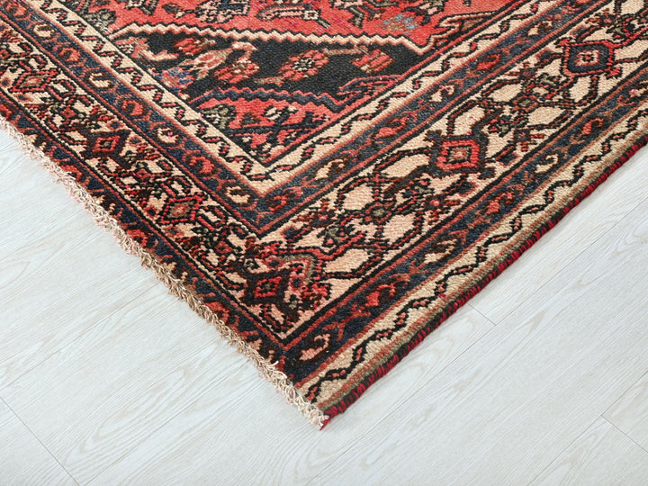 a red and black oriental rug on a white floor