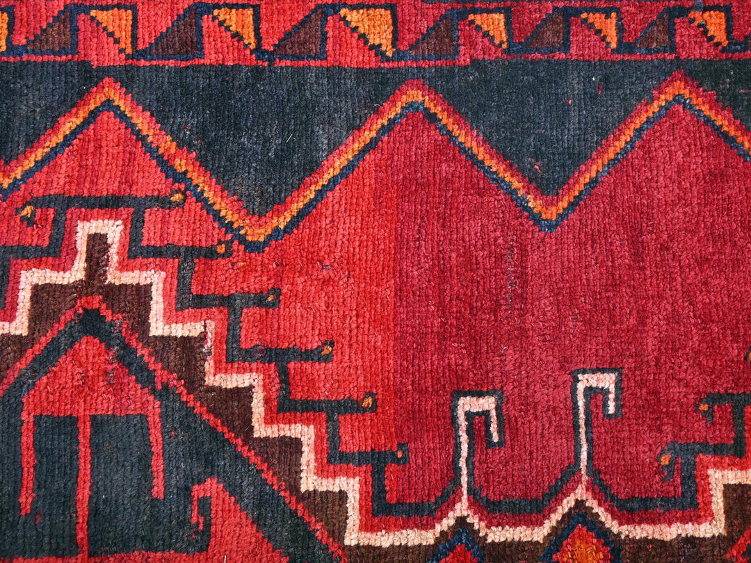 a close up of a rug with a red background