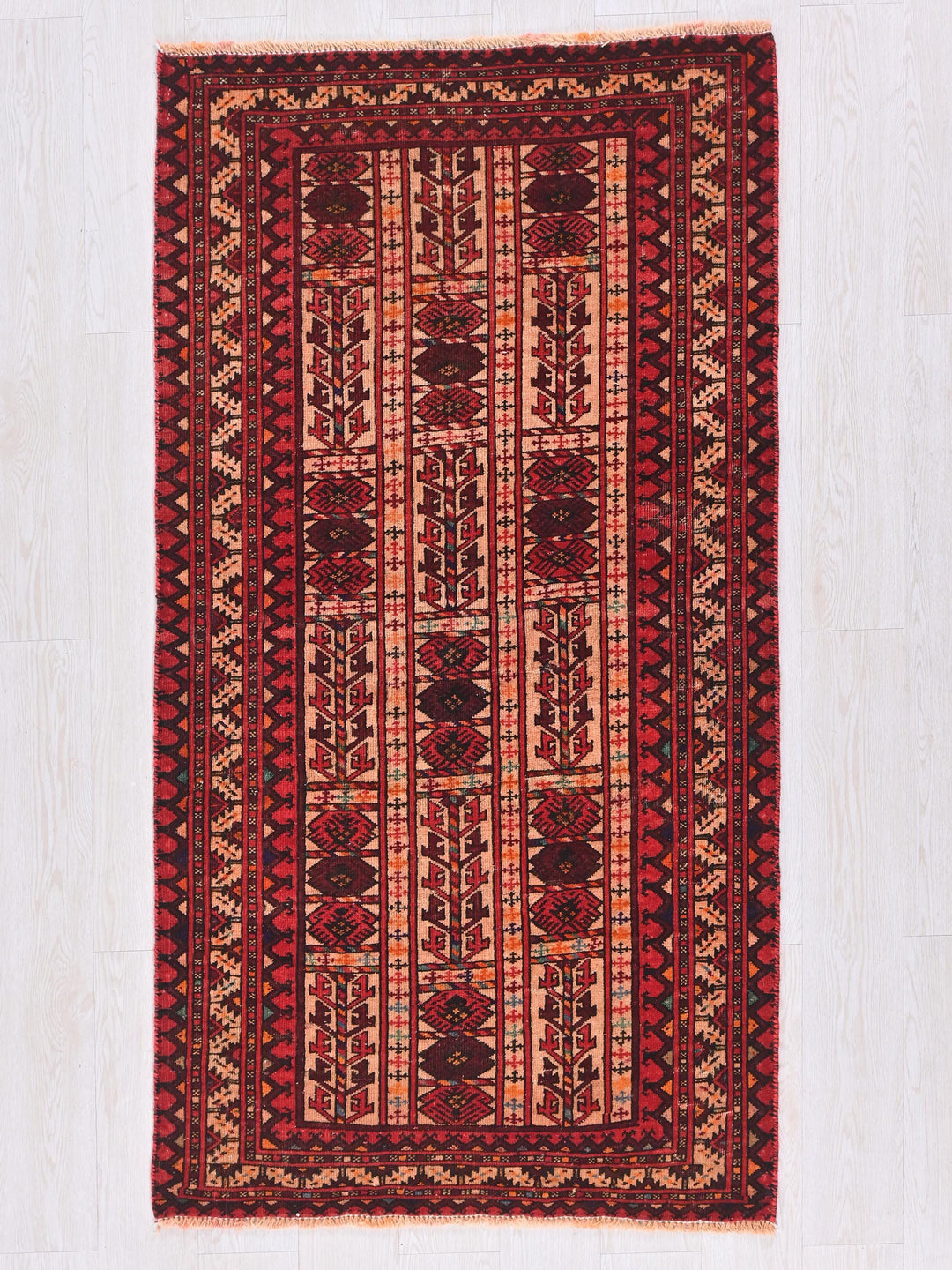 a red rug on a white wooden floor
