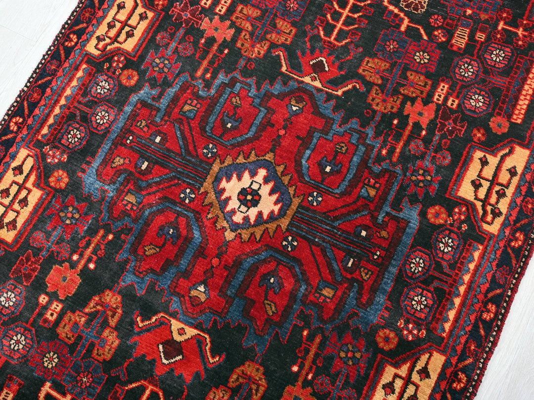 a red and blue rug on a white floor