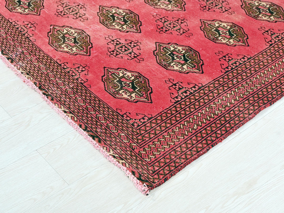 a red rug with a design on it
