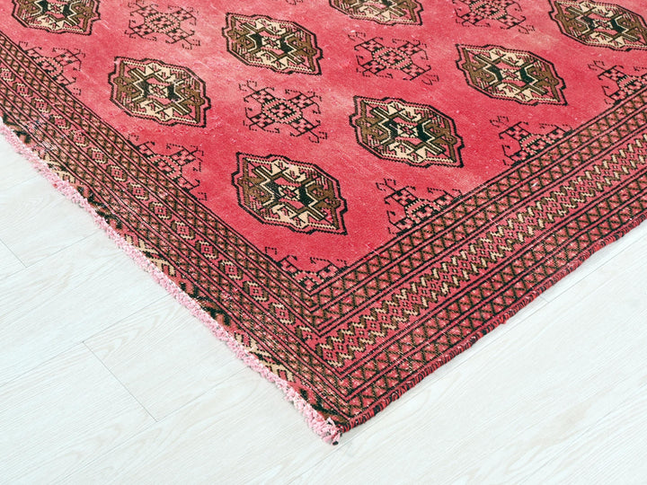 a red rug with a design on it