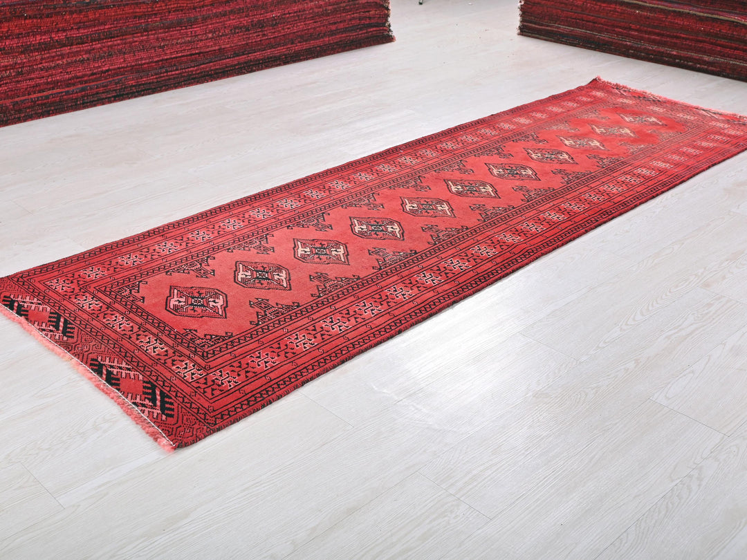 a red rug is laying on a white floor