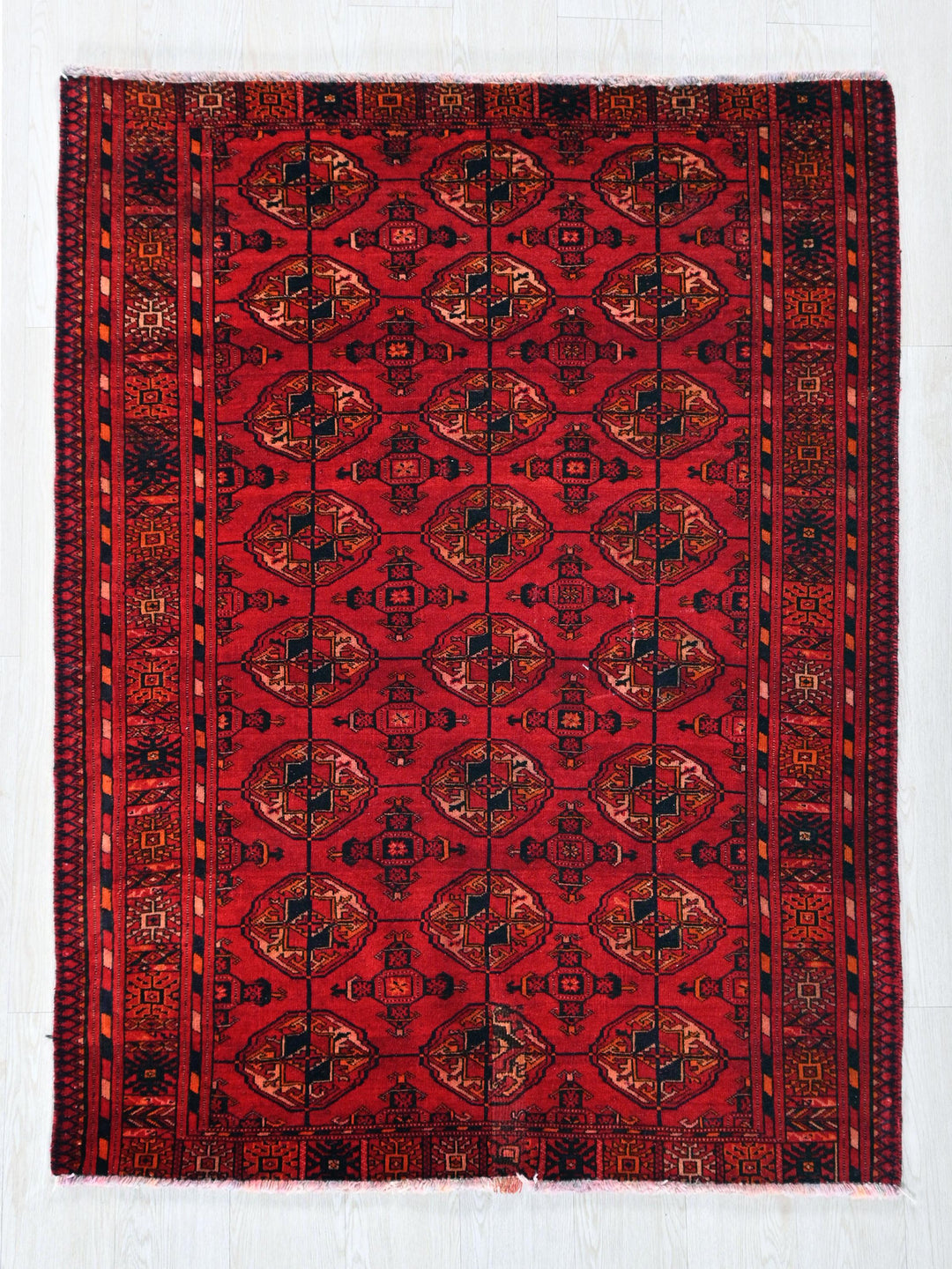 a red rug with a design on it