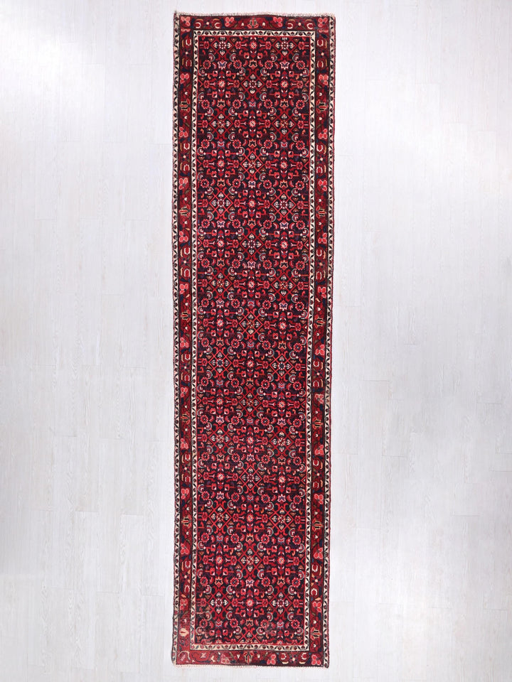 a red and black rug on a white wall