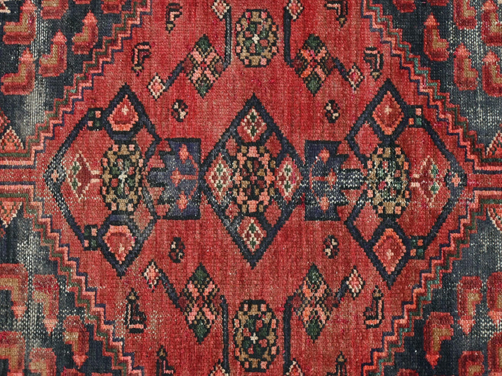 a red rug with a diamond pattern on it