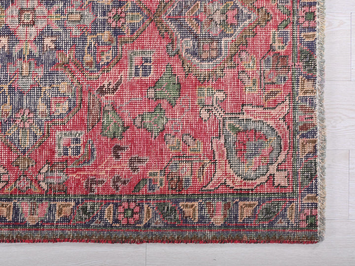 a pink rug with a floral design on it